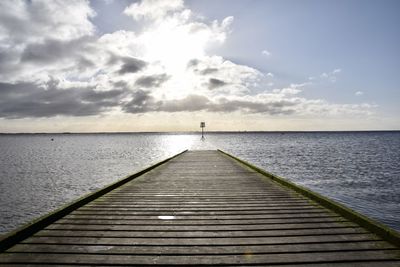 Pier over sea against sky