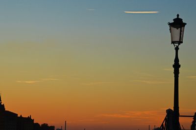 Low angle view of street light against sky at sunset