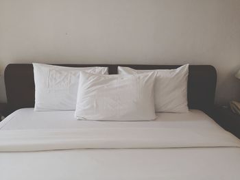 White sofa in bed against wall at home