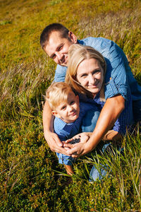 Full length of father and daughter on grass