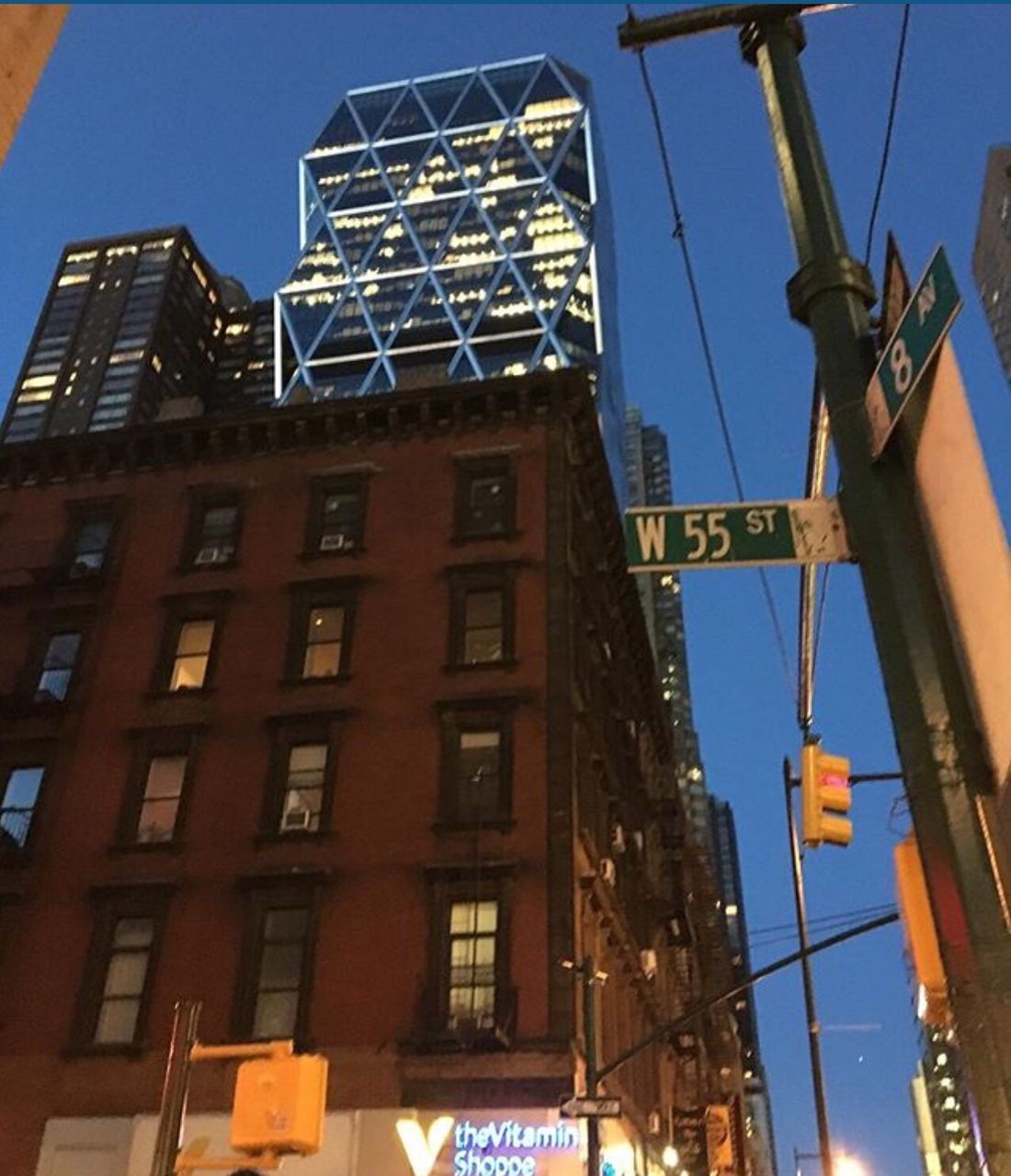 LOW ANGLE VIEW OF BUILDINGS AGAINST BLUE SKY