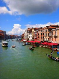 Boats in river with buildings in background