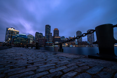 Illuminated buildings in city at dusk