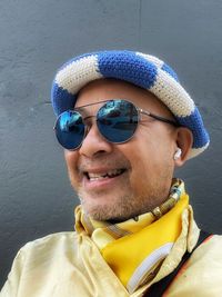 Portrait of man wearing sunglasses and scarf. 