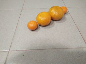 High angle view of orange fruits on floor