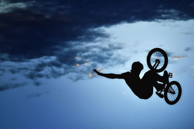 Low angle view of man riding bike