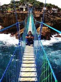 Low angle view of man on footbridge