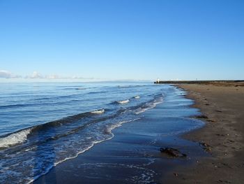 Scenic view of sea against clear blue sky