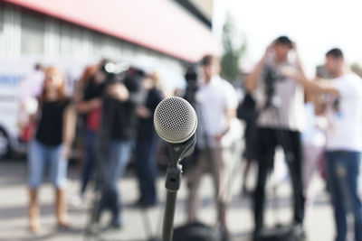 Close-up of microphone against crowd