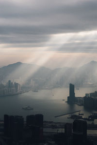 View of cityscape against dramatic sky