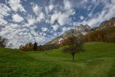 Scenic view of mountains against cloudy sky