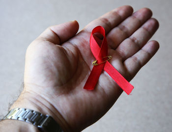 Close-up of hand holding red ring