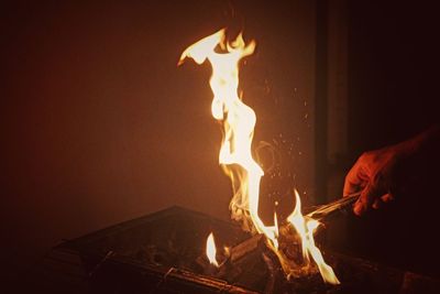 Midsection of person holding burning fire