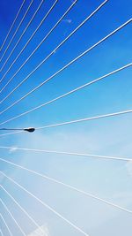 Low angle view of bridge against blue sky during sunny day