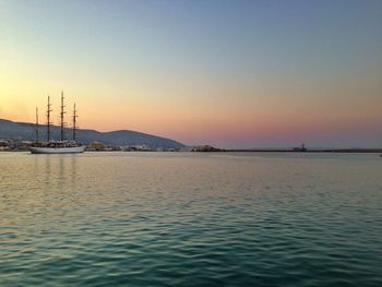 Sailboat in sea at sunset