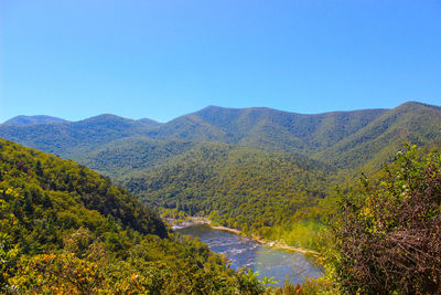 Scenic view of mountains against clear blue sky