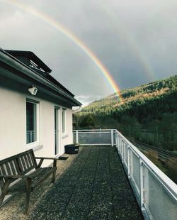 Rainbow over building against sky