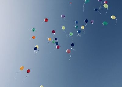 Low angle view of balloons against sky