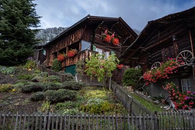 Low angle view of houses on mountain against sky