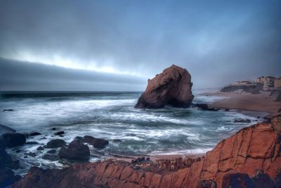 Scenic view of sea against cloudy sky