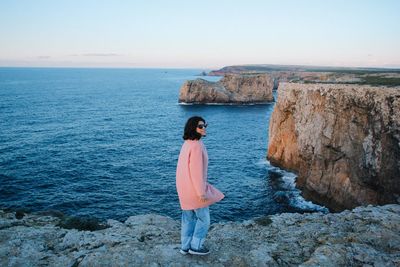 Woman on beach against sky