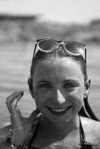 Close-up portrait of smiling woman in sea