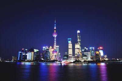 Bay against oriental pearl tower and buildings and night