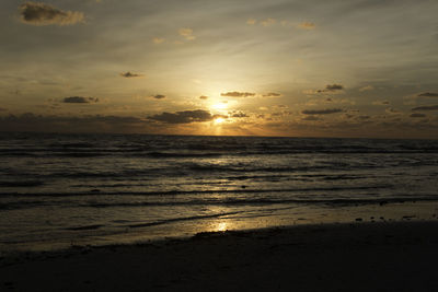 Scenic view of beach against sky during sunset