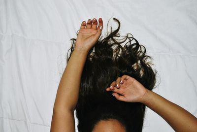 Cropped image of woman lying on bed