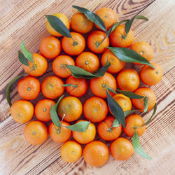 Mandarines in the middle of wooden background