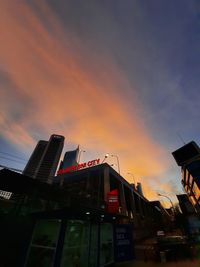 Low angle view of illuminated buildings against sky during sunset