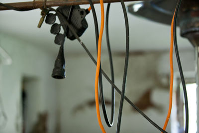 Low angle view of bicycle hanging on rope