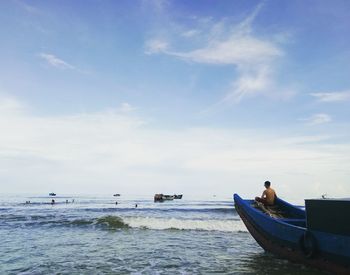 Boat moored on sea against sky