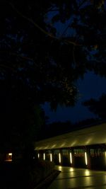 Low angle view of illuminated bridge at night