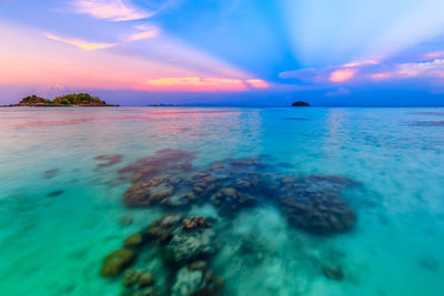 Scenic view of sea against sunset sky