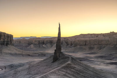 Scenic view of desert against sky during sunset