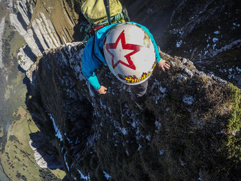 High angle view of child on rock during winter