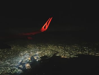 Aerial view of illuminated city against sky at night