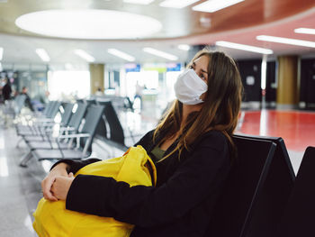 Tired woman sitting at airport