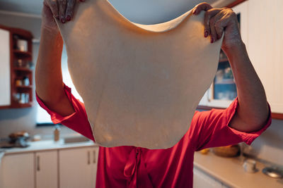 Close shot of a woman holding dough for polish dumplings. home-made food.