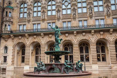 Hygieia fountain in the courtyard of hamburg city hall in a cold rainy early spring day