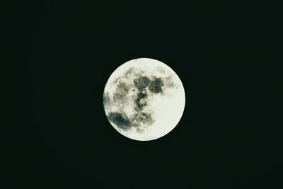 Low angle view of moon against clear sky at night