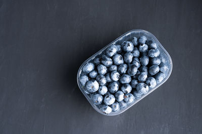 High angle view of blueberries in bowl on table