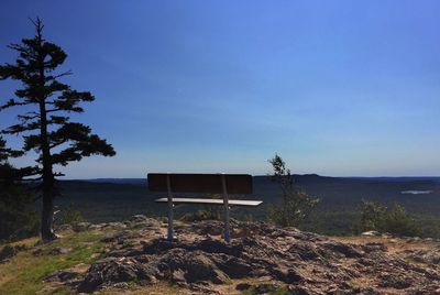 Lifeguard hut on landscape against clear sky