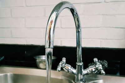 Close-up of faucet in kitchen at home