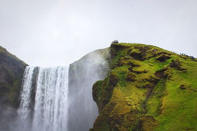 Low angle view of waterfall against sky