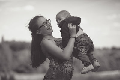 Smiling mother holding baby boy