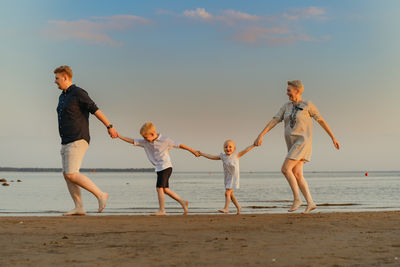 Full length of couple walking at beach