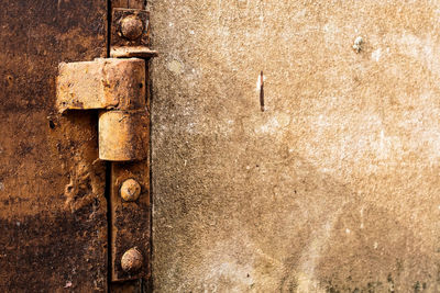 Close-up of hinge on rusty metal