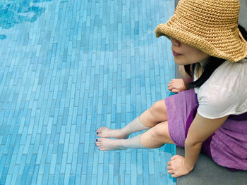 High angle view of woman sitting in swimming pool